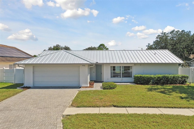 ranch-style house featuring a front yard and a garage