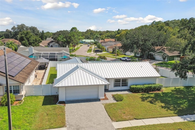 view of front of property with a front yard and a garage