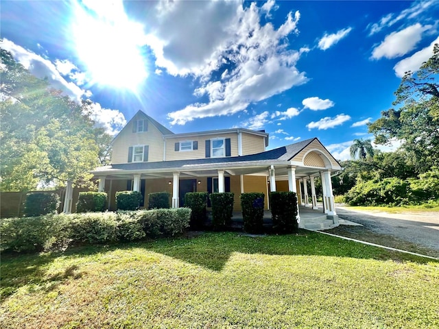 view of front of home featuring a front yard and covered porch