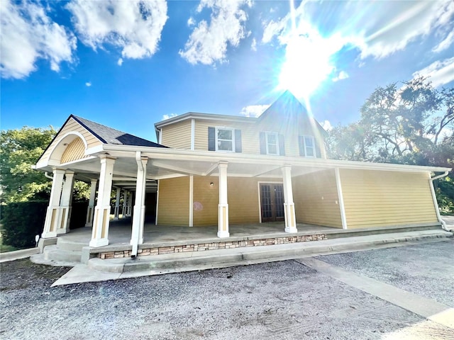 rear view of house with covered porch