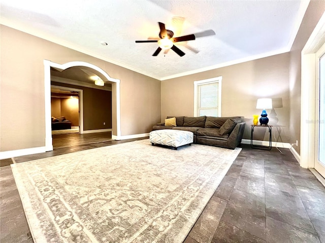 living room featuring ceiling fan, a textured ceiling, and crown molding