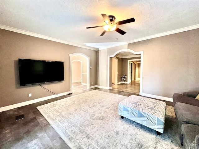 living room with hardwood / wood-style floors, ceiling fan, a textured ceiling, and ornamental molding