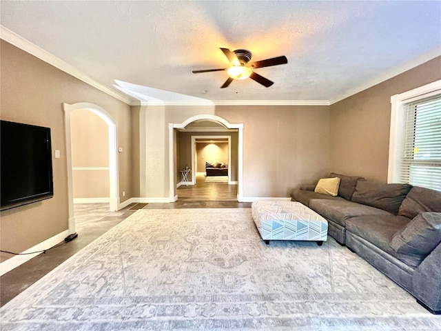 living room with hardwood / wood-style floors, ceiling fan, a textured ceiling, and ornamental molding