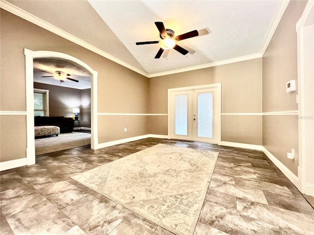 foyer with french doors, lofted ceiling, ceiling fan, and crown molding