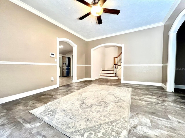 interior space featuring ceiling fan, a textured ceiling, and ornamental molding