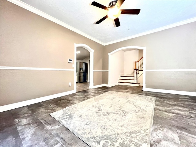 spare room with a textured ceiling, ceiling fan, and crown molding