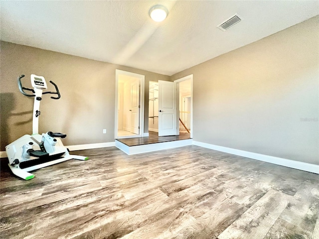 workout room featuring wood-type flooring