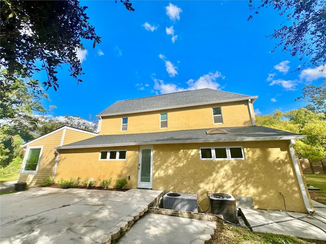 rear view of property featuring central air condition unit and a patio