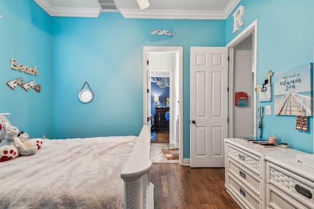 bedroom with dark hardwood / wood-style flooring and crown molding