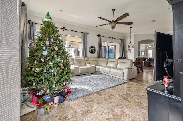 living room featuring crown molding, ceiling fan, and light tile patterned floors