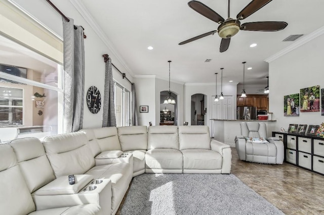 living room with crown molding and ceiling fan