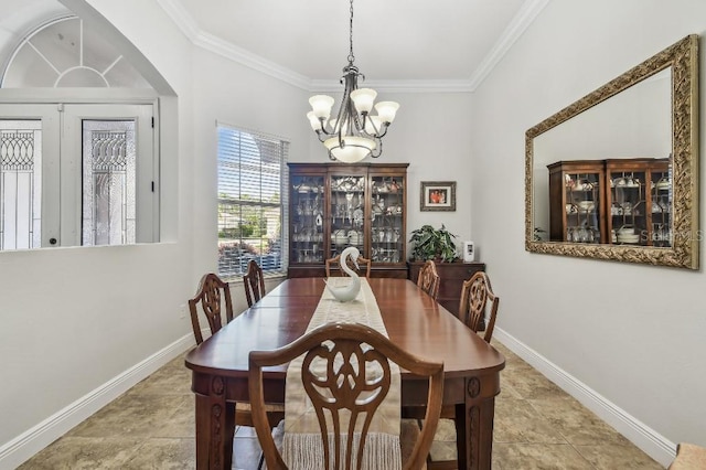 dining room featuring light tile patterned floors, crown molding, and a chandelier