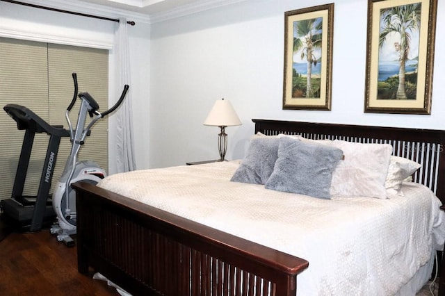 bedroom with crown molding and dark hardwood / wood-style floors