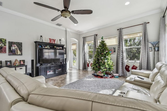 living room with crown molding, ceiling fan, tile patterned flooring, and a wealth of natural light