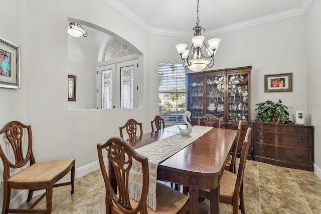 dining area with an inviting chandelier, ornamental molding, and light tile patterned floors