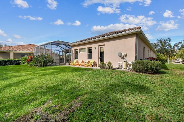 view of side of home with a yard and a lanai