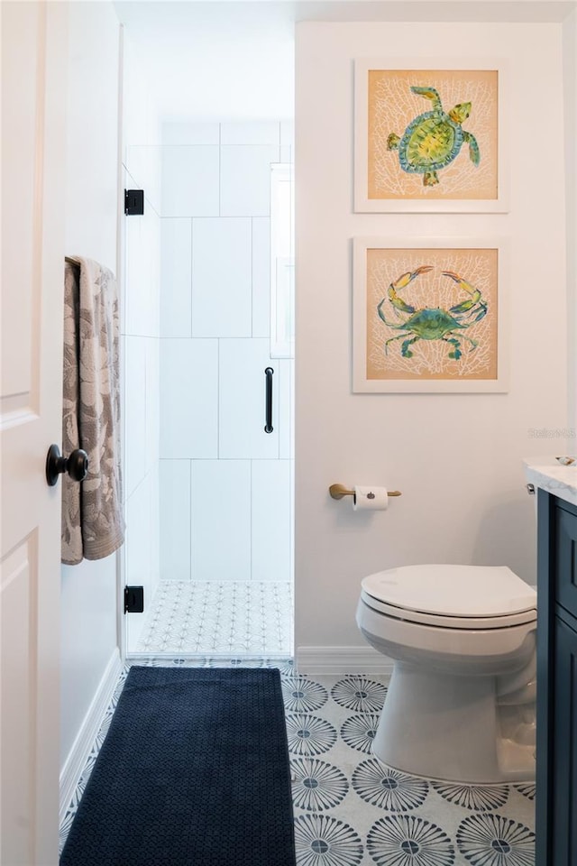 bathroom featuring vanity, toilet, and an enclosed shower