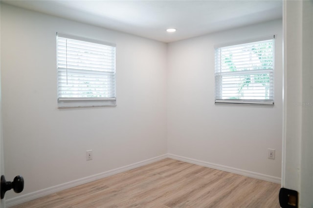 spare room with light hardwood / wood-style floors