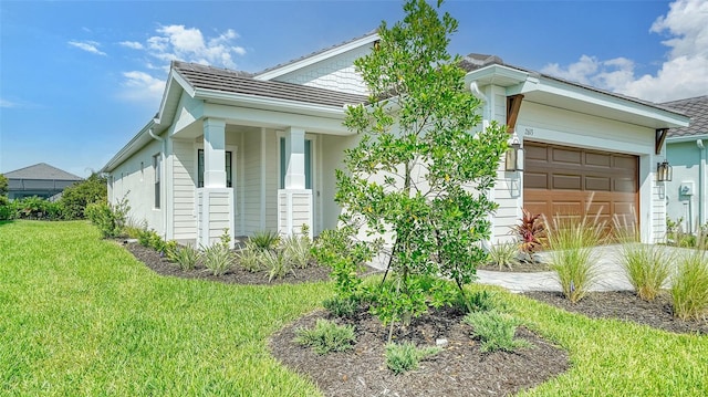 view of front of home with a garage and a front lawn