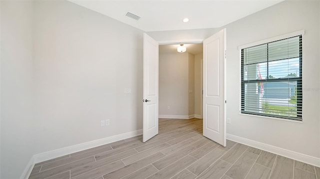 spare room featuring light hardwood / wood-style flooring