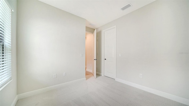 empty room featuring light carpet