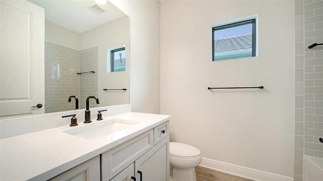 bathroom with vanity, toilet, and wood-type flooring