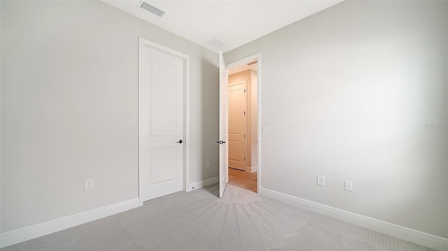 unfurnished bedroom featuring light colored carpet