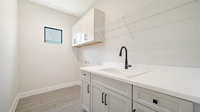 laundry area featuring washer hookup, cabinets, and sink