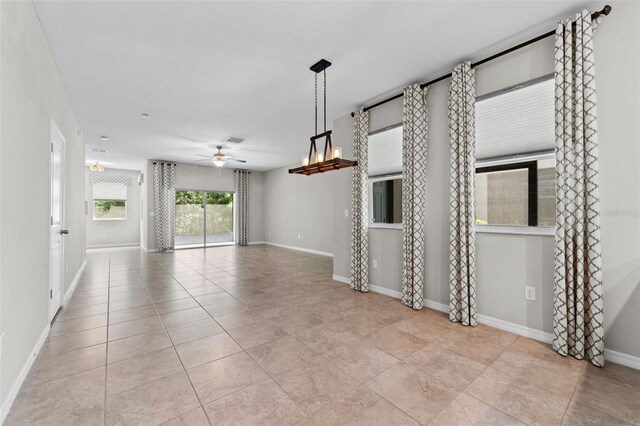 tiled spare room with ceiling fan