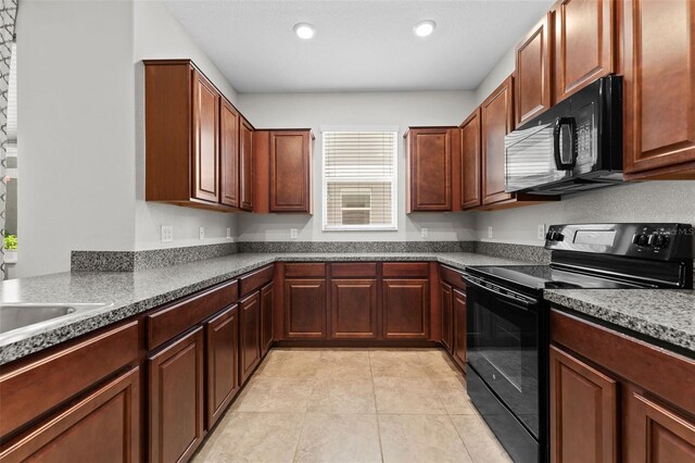 kitchen with black appliances and light tile patterned floors