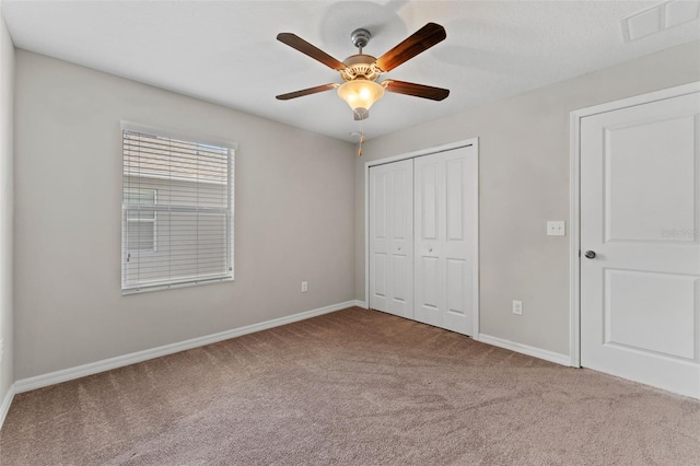 unfurnished bedroom with a closet, ceiling fan, and carpet