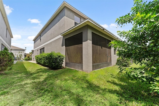 view of side of property with a lawn