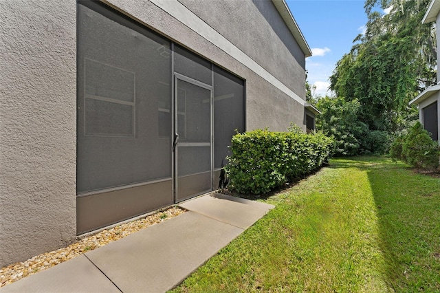 view of side of home with a yard