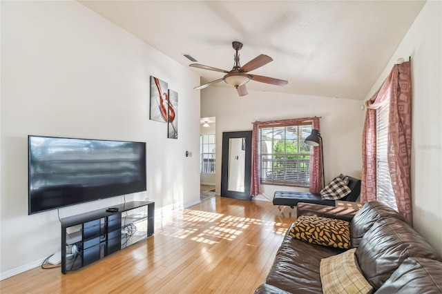 living room featuring ceiling fan, light hardwood / wood-style flooring, and lofted ceiling