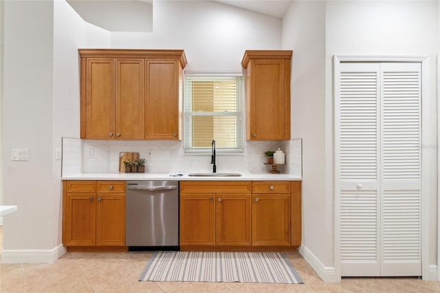 kitchen with dishwasher, tasteful backsplash, sink, lofted ceiling, and light tile patterned floors