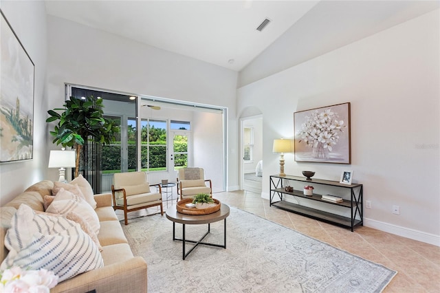 tiled living room with high vaulted ceiling