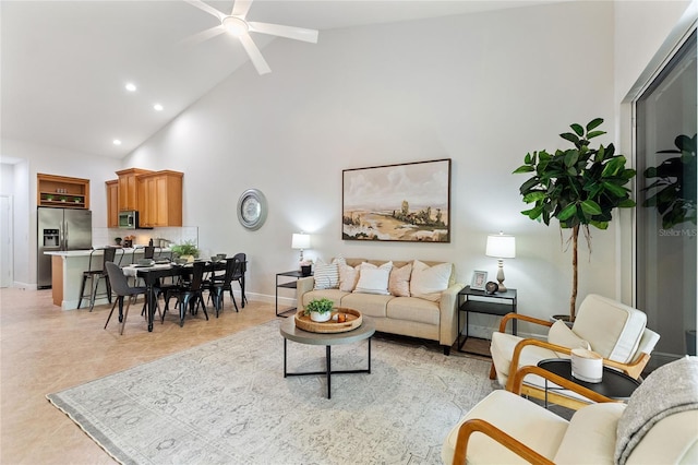 tiled living room featuring ceiling fan and high vaulted ceiling