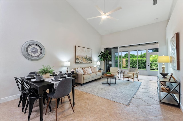 tiled living room featuring ceiling fan, high vaulted ceiling, and french doors