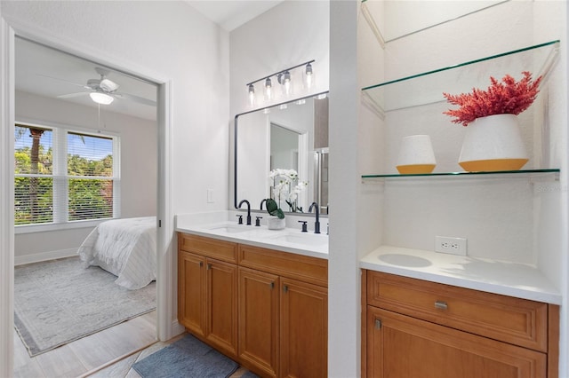 bathroom featuring ceiling fan, hardwood / wood-style floors, and vanity