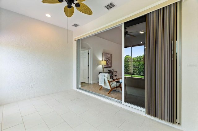 spare room featuring ceiling fan and light tile patterned floors