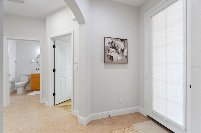 hallway featuring light tile patterned floors