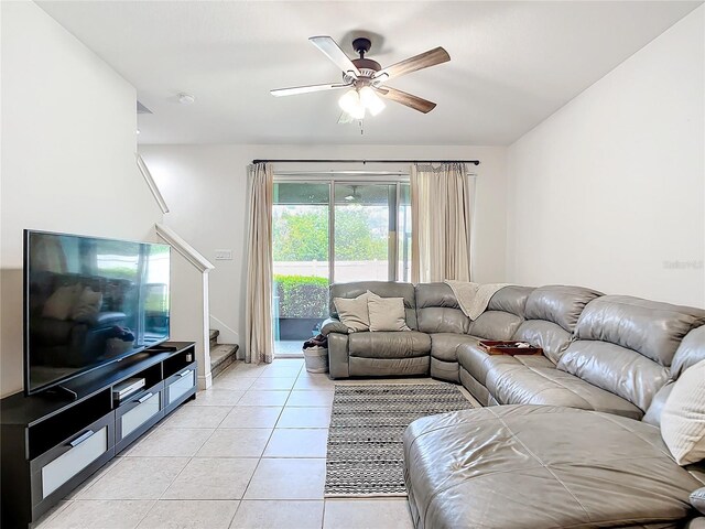 tiled living room with ceiling fan