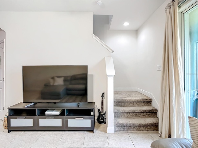 stairs featuring a wealth of natural light and tile patterned flooring