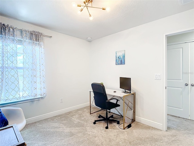 office featuring light colored carpet and an inviting chandelier