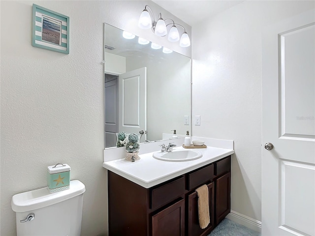 bathroom featuring toilet and vanity