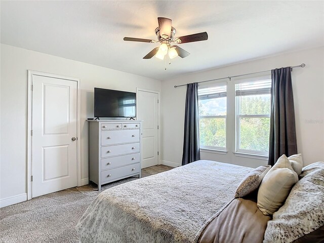 bedroom featuring light carpet and ceiling fan