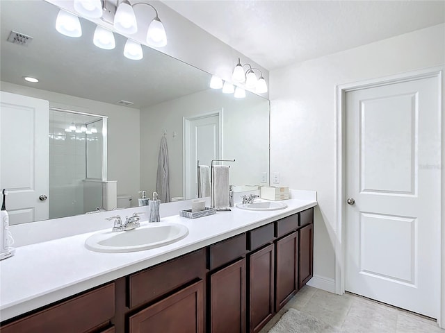 bathroom with tile patterned floors, a shower with door, and vanity