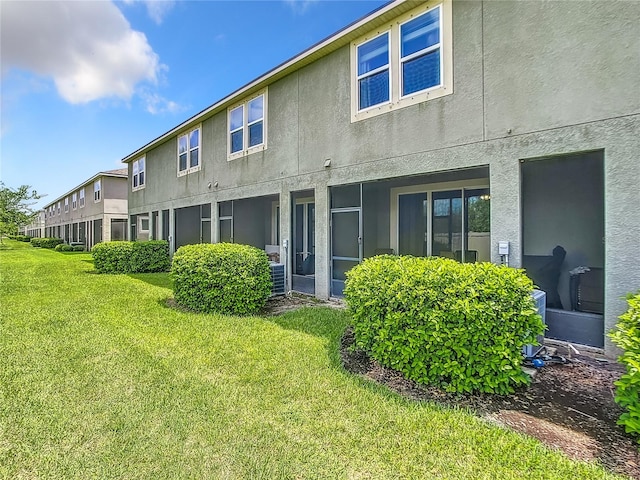 rear view of house with a yard