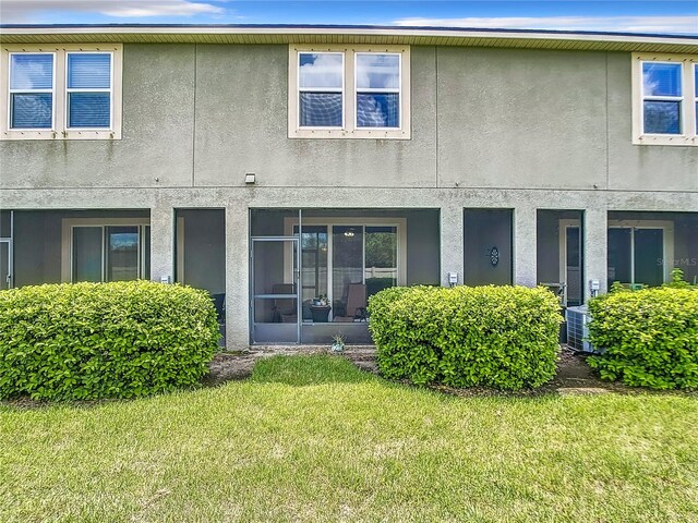 rear view of house featuring a yard