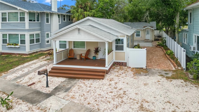 rear view of house featuring a wooden deck